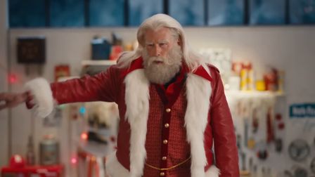 It's Grease on Earth, as John Travolta's Santa is back